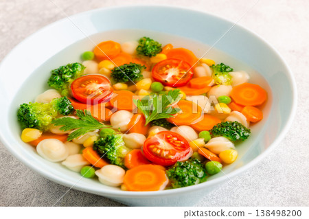 Soup with mini dumplings and vegetables. 138498200