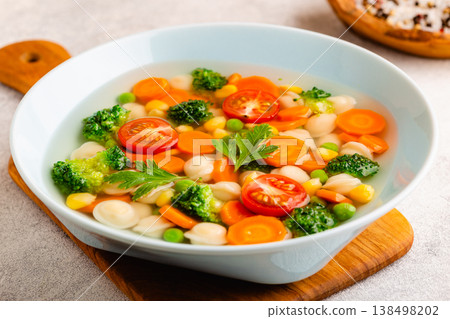 Soup with mini dumplings and vegetables. 138498202