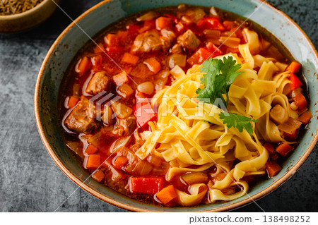 Lagman soup with lamb, homemade noodles and vegetables. Lagman soup with lamb, homemade noodles and vegetables. 138498252