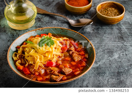 Lagman soup with lamb, homemade noodles and vegetables. 138498253