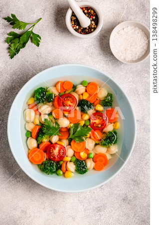 Soup with mini dumplings and vegetables. 138498299