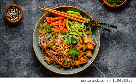 Soba noodles with vegetables and fried tofu in a bowl. Soba noodles with vegetables and fried tofu in a bowl. 138498355