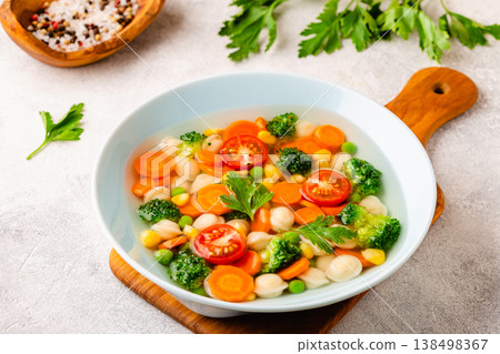Soup with mini dumplings and vegetables. 138498367