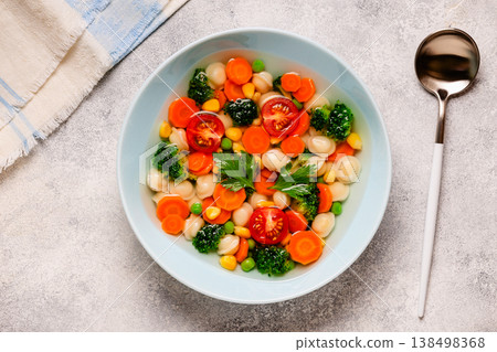 Soup with mini dumplings and vegetables. 138498368