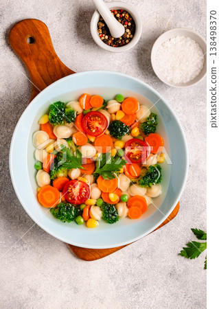 Soup with mini dumplings and vegetables. 138498370