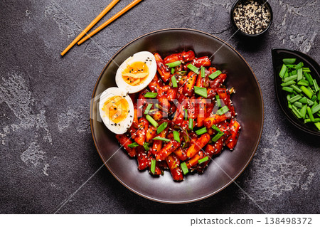 Tteokbokki, Teopokki fried rice cake in black bowl. 138498372