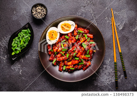 Tteokbokki, Teopokki fried rice cake in black bowl. Tteokbokki, Teopokki fried rice cake in black bowl. 138498373