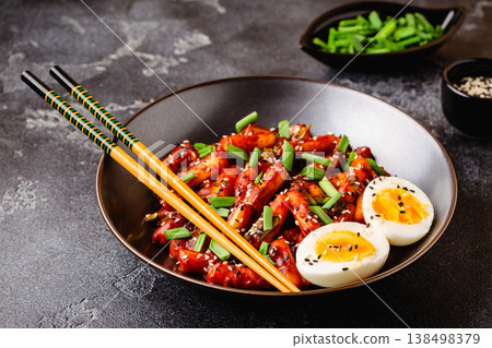 Tteokbokki, Teopokki fried rice cake in black bowl. Tteokbokki, Teopokki fried rice cake in black bowl. 138498379