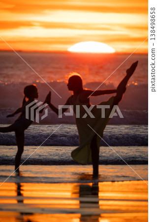 Mother and child balancing on sunset beach Mother and child balancing on sunset beach 138498658
