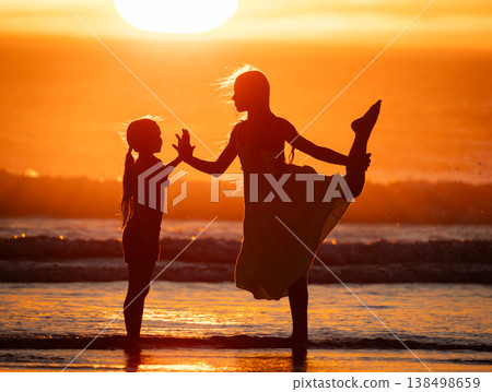 Girls playing and dancing on beach at sunset Girls playing and dancing on beach at sunset 138498659