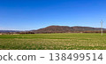 Rural landscape with green field hills and blue sky in countryside panorama with spring meadow nature view 138499514