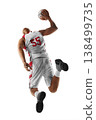 Basketball. Dynamic action shot of a basketball player in mid air holding the ball during a jump shot. Sport. Isolated 138499735