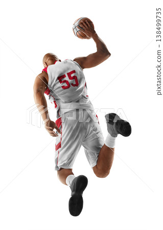 Basketball. Dynamic action shot of a basketball player in mid air holding the ball during a jump shot. Sport. Isolated 138499735
