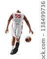 Basketball player. Dynamic rear view of a basketball player dribbling the ball during a game. Isolated on a white background 138499736