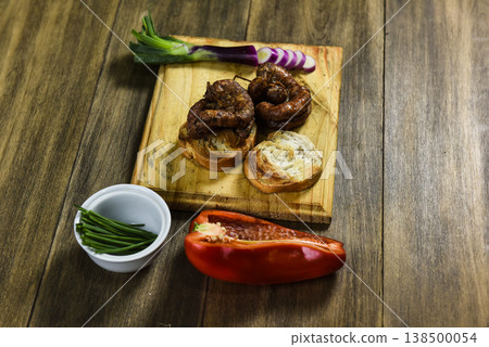 Cow bowels presented on a wooden board with ingredients, ready to grill Cow bowels presented on a wooden board with ingredients, ready to grill 138500054