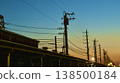 Power lines stretching into the twilight sky and the quiet cityscape 138500184