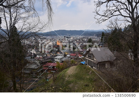 The beautiful townscape of Nakabashi area in the center of Takayama City, Gifu Prefecture, Japan, with cherry blossoms in spring bud and old and new houses, as seen from Shiroyama Park. The beautiful townscape of Nakabashi area in the center of Takayama City, Gifu Prefecture, Japan, with cherry blossoms in spring bud and old and new houses, as seen from Shiroyama Park. 138500690