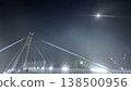 A fantastical scene of a cable-stayed bridge at night, under the moonlight and illuminated by streetlights. 138500956