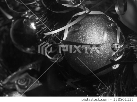 New Year's ball glitters ribbons decorated Christmas tree, close-up grey color dark New Year's ball glitters ribbons decorated Christmas tree, close-up grey color dark 138501135