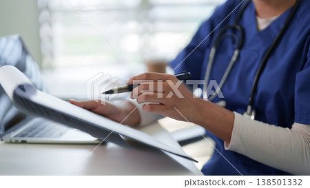 Healthcare professional diligently records patient information at a medical facility focusing on comprehensive patient care efficient documentation and data management Healthcare professional diligently records patient information at a medical facility focusing on comprehensive patient care efficient documentation and data management 138501332