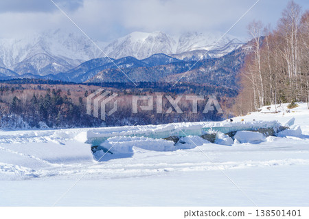 The Taushubetsu River Bridge, buried in snow, is a relic of the former Japanese National Railways in Tokachi, Hokkaido. 138501401
