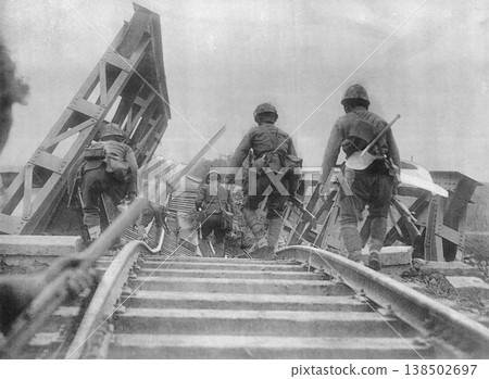 Old photograph, November 1937, during the Second Sino-Japanese War: Japanese Army troops advancing along destroyed railway tracks to the banks of the Yellow River. Old photograph, November 1937, during the Second Sino-Japanese War: Japanese Army troops advancing along destroyed railway tracks to the banks of the Yellow River. 138502697