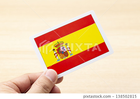 A hand holding a Spanish flag card 138502815