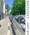 Cars parked along the street in a green area 138502998