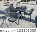 Tables and chairs placed in a sunny outdoor area 138503005