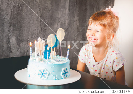 The child blows out the candles on the cake. The child blows out the candles on the cake. 138503129