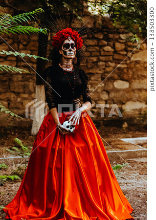 Day of the Dead. Portrait of a woman with a wreath and wearing a full-length skull costume. Artistic composition. Day of the Dead. Portrait of a woman with a wreath and wearing a full-length skull costume. Artistic composition. 138503300