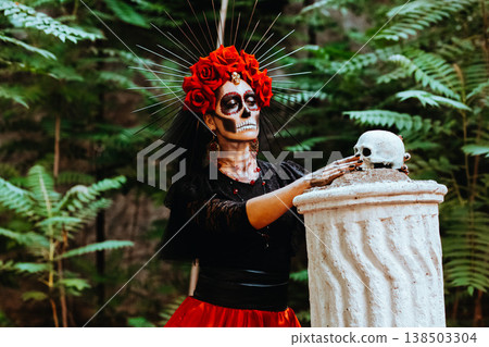 Day of the Dead. Portrait of a woman with a wreath of red roses and a skull on a column. 138503304