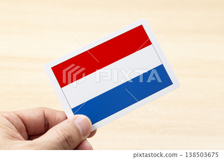 A hand holding a Dutch flag card A hand holding a Dutch flag card 138503675
