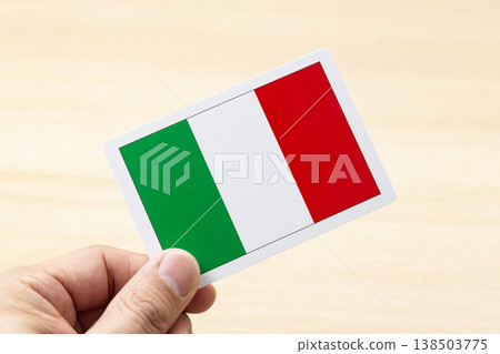 A hand holding an Italian flag card A hand holding an Italian flag card 138503775