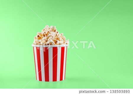 Classic red striped popcorn cardboard cup on Green background Classic red striped popcorn cardboard cup on Green background 138503893