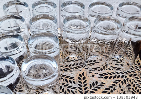 Clear Glass Tumbler Arranged on a Decorative Tray for Elegant Table Styling Clear Glass Tumbler Arranged on a Decorative Tray for Elegant Table Styling 138503948