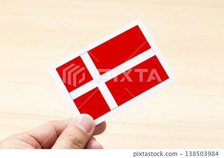 A hand holding a Danish flag card A hand holding a Danish flag card 138503984