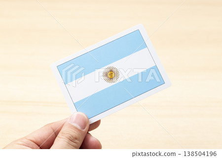 A hand holding an Argentine flag card A hand holding an Argentine flag card 138504196