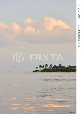 Classic Maldives island landscape on a sunset, azure water, white sand, palm trees on the shore Classic Maldives island landscape on a sunset, azure water, white sand, palm trees on the shore 138504300