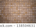Stone mosaic tiles creating a uniform wall pattern, showing variations in natural material and subtle color tones, ideal for architectural and decorative backdrop designs 138504631