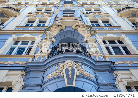 Ornate blue baroque facade with cherubs and balcony 138504771