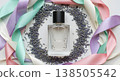 Perfume Bottle Surrounded By Lavender And Pastel Ribbons On White Background 138505542