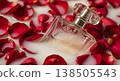 Perfume Bottle Surrounded By Red Rose Petals In A Milky Liquid With Soft Lighting 138505543