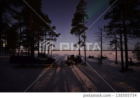 In Inari, in the Finnish Lapland region, a fantastical green aurora appeared above a snow-covered cottage. In Inari, in the Finnish Lapland region, a fantastical green aurora appeared above a snow-covered cottage. 138505734