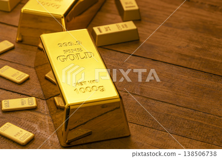 Fine Gold Bars and Bullion Arranged on Wooden Table - Precious Metal Investment and Wealth 138506738