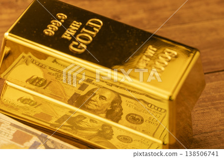 Gold Bar and US Dollar Bills Stacked Together - Precious Metals and Currency Financial Wealth Investment 138506741
