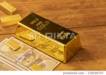 Stacked Gold Bullion Bars with US Currency - Financial Wealth, Investment Portfolio and Money Concept Stacked Gold Bullion Bars with US Currency - Financial Wealth, Investment Portfolio and Money Concept 138506747