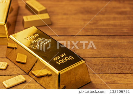 Gold Bars and Bullion Displayed on Wooden Surface - Precious Metals, Wealth, and Investment Concept 138506751