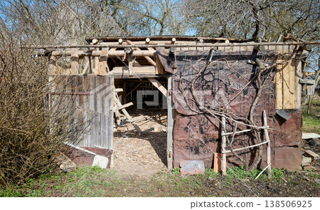 Demolition of an old wooden shed in the garden. Demolition of an old wooden shed in the garden. 138506925