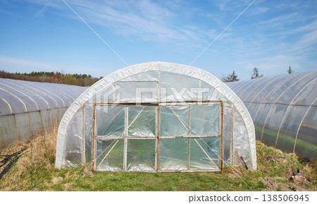 Greenhouses covered with polyethylene foil on an organic vegetable farm. Greenhouses covered with polyethylene foil on an organic vegetable farm. 138506945